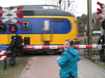 SX02867 Jenni on Machteld's bike waiting for train on level crossing.jpg